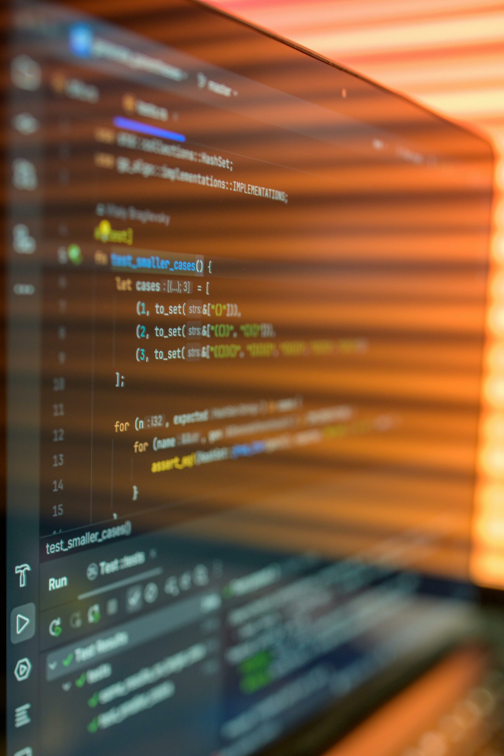 Close-up image of a computer screen displaying colorful programming code in a warm setting.